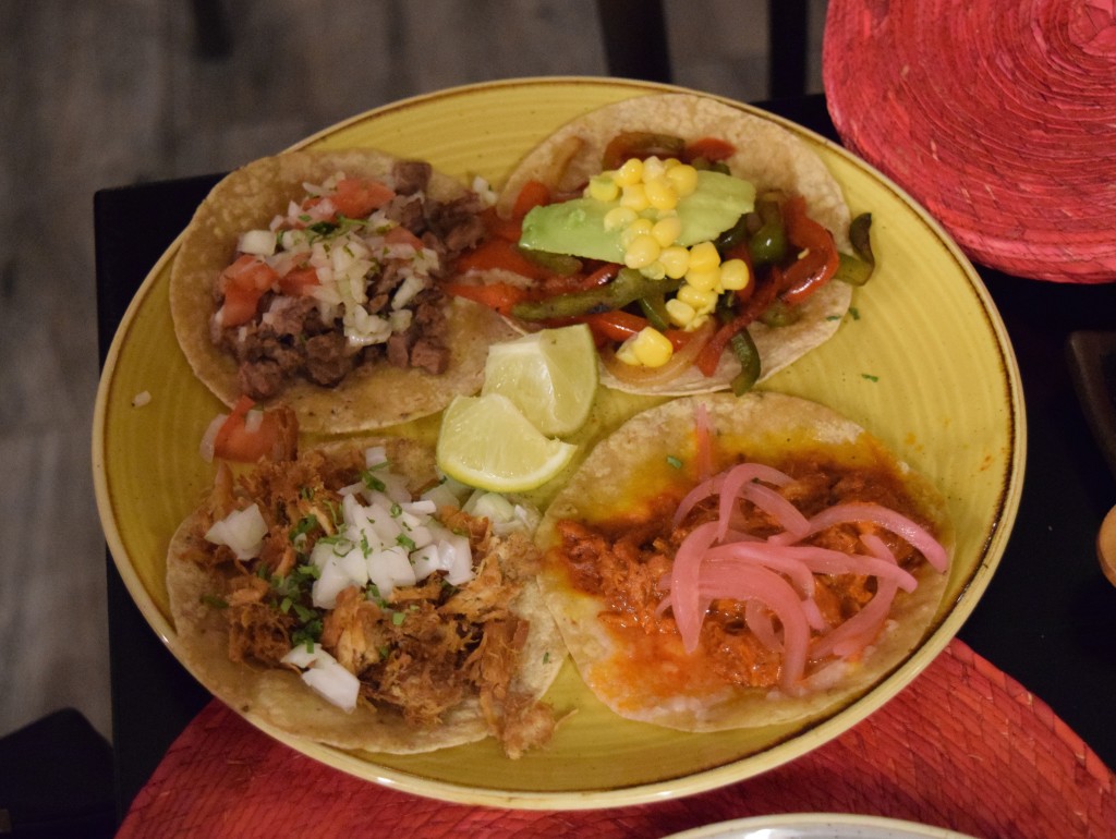Mexican tacos with pork, beef, vegetables, and pickled onions